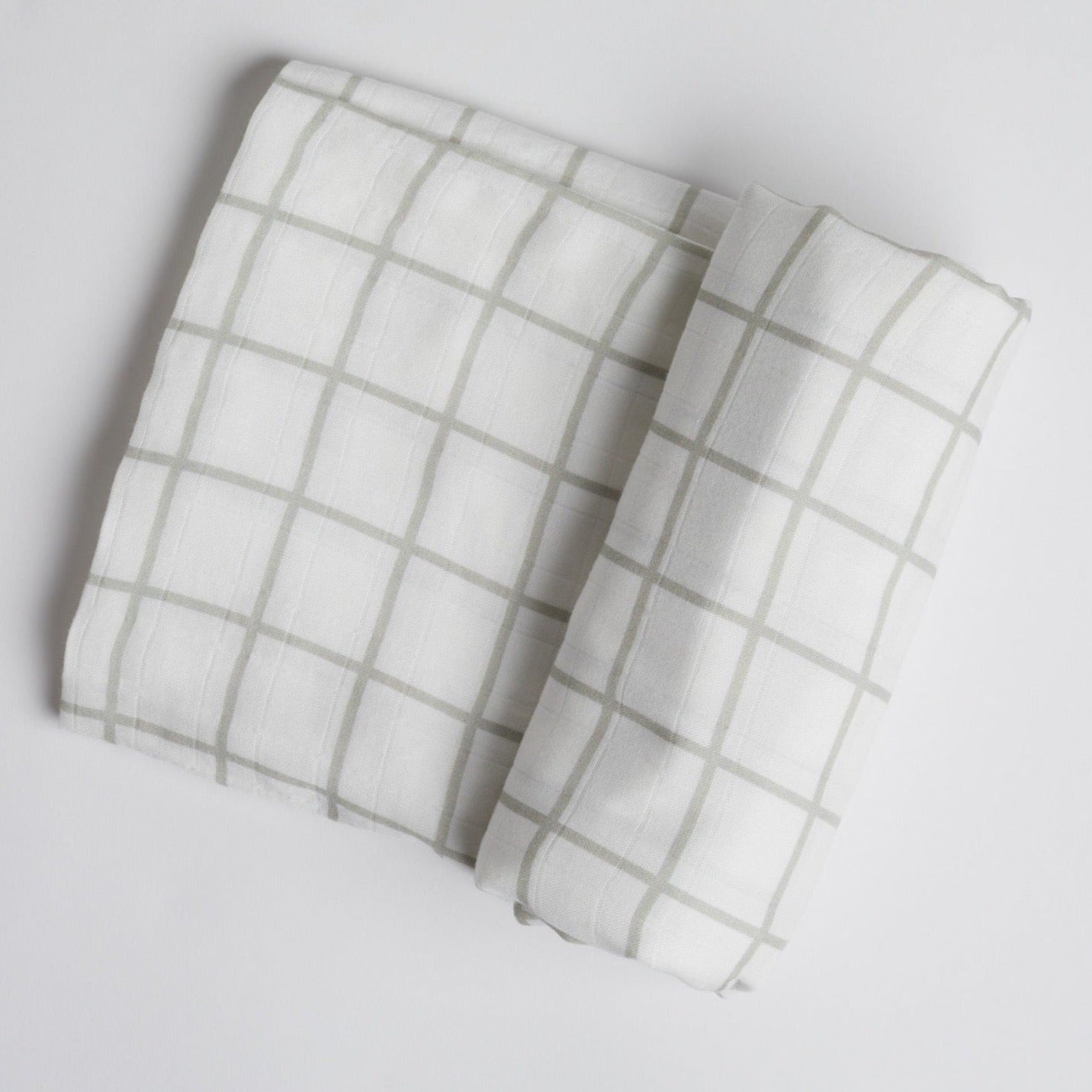 Sage Green Window Pane Swaddle on white background.