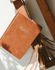 brown leather journal that says 'NOTES' on it in gold