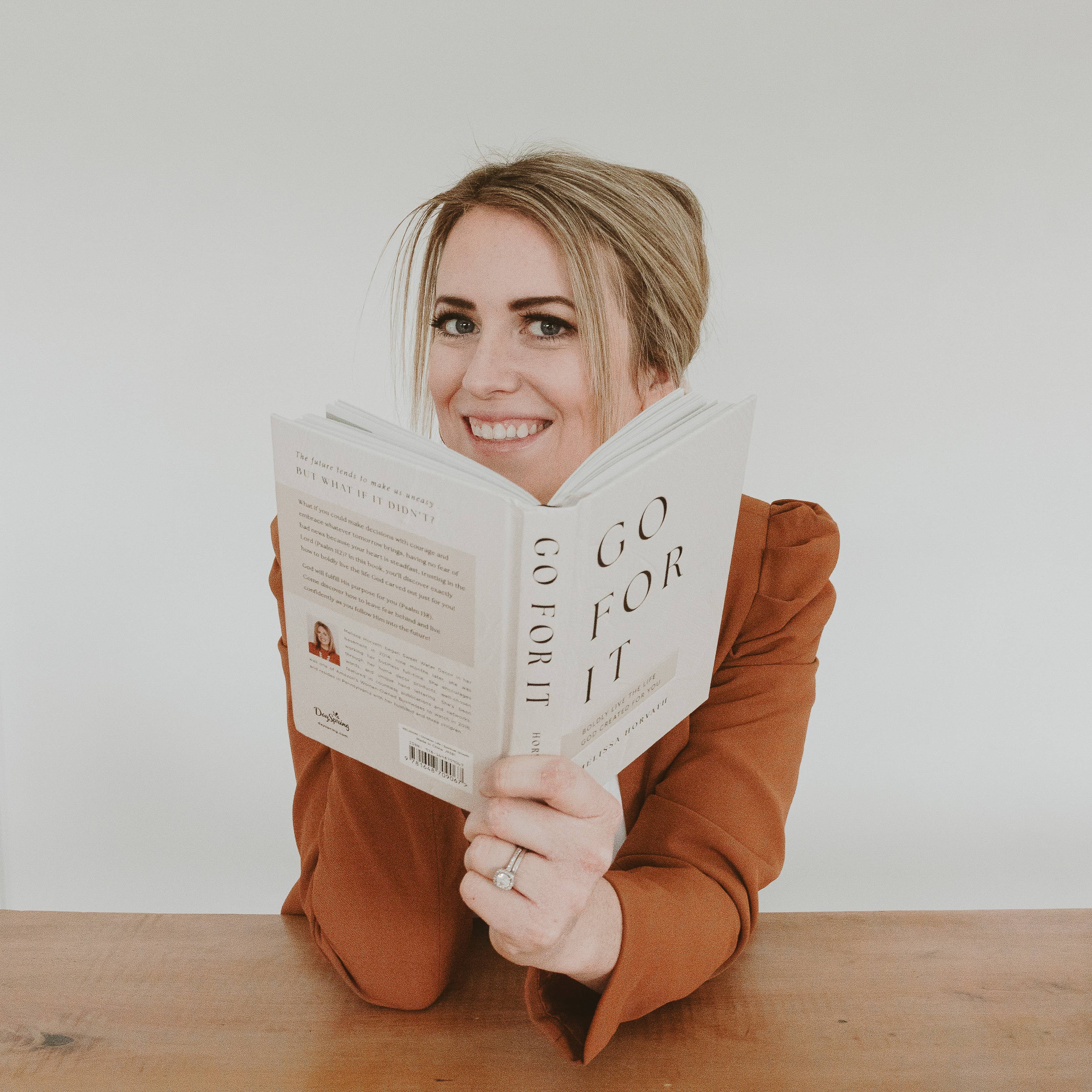 woman holding GO FOR IT journal