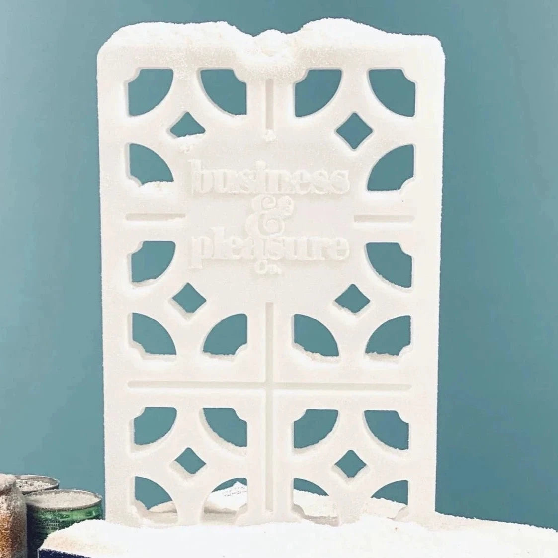 Breeze Block Ice Pack on "snow" in front of blue background.