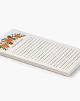 Shopping list notepad with two checklists and fall floral print at the top