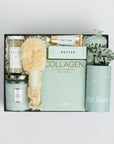 The GREEN GODDESS gift box in black, including DETOX bath salts, large candle, dry brush, collagen face mask, hand cream, scalp scrubber, silk scrunchie and hair towel.