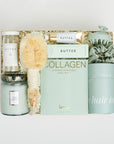 The GREEN GODDESS gift box in creme, including DETOX bath salts, large candle, dry brush, collagen face mask, hand cream, scalp scrubber, silk scrunchie and hair towel.