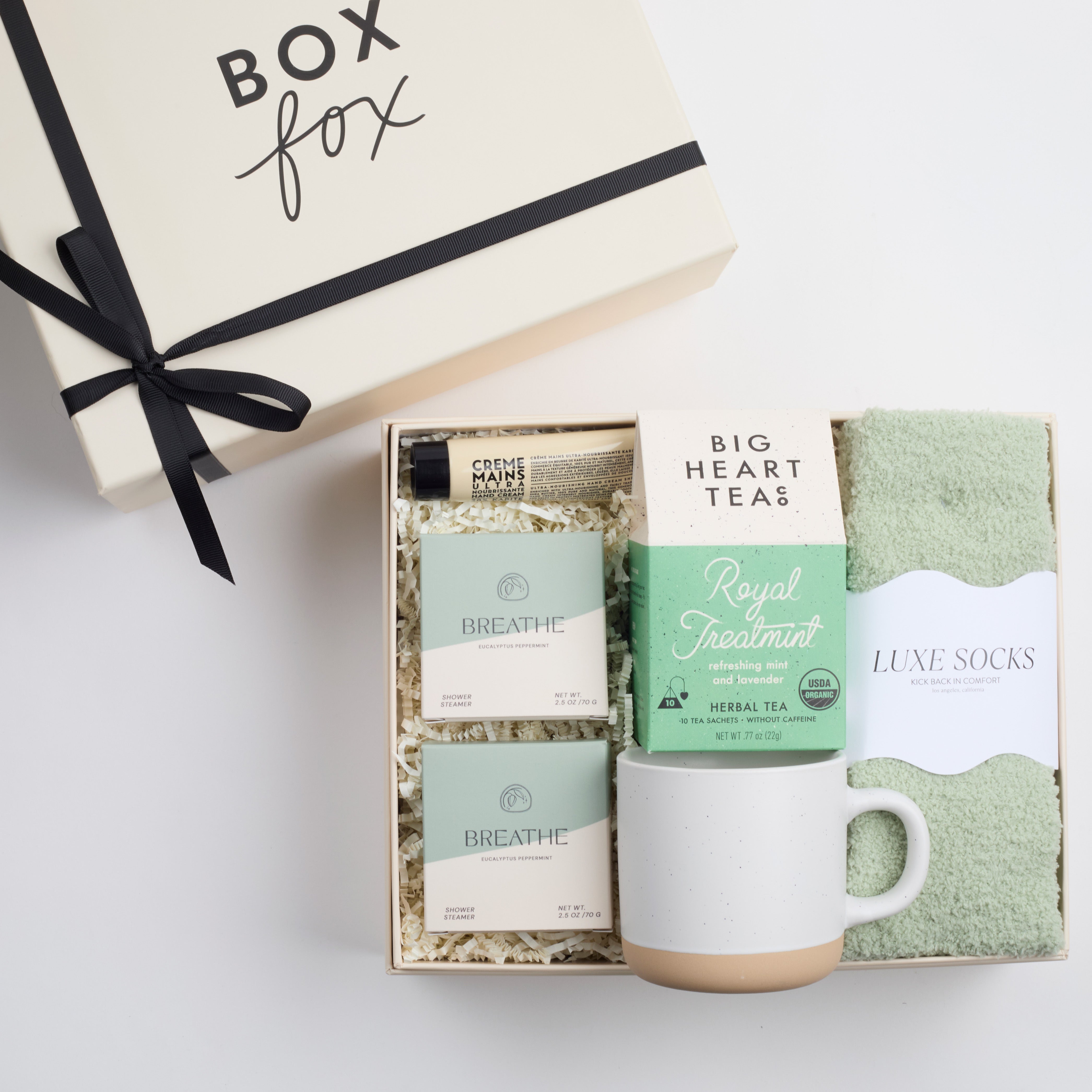 BOXFOX HEAL Gift Box with 2 shower steamers, a travel hand cream, mint & lavender tea, a speckled ceramic mug, and sage cozy socks