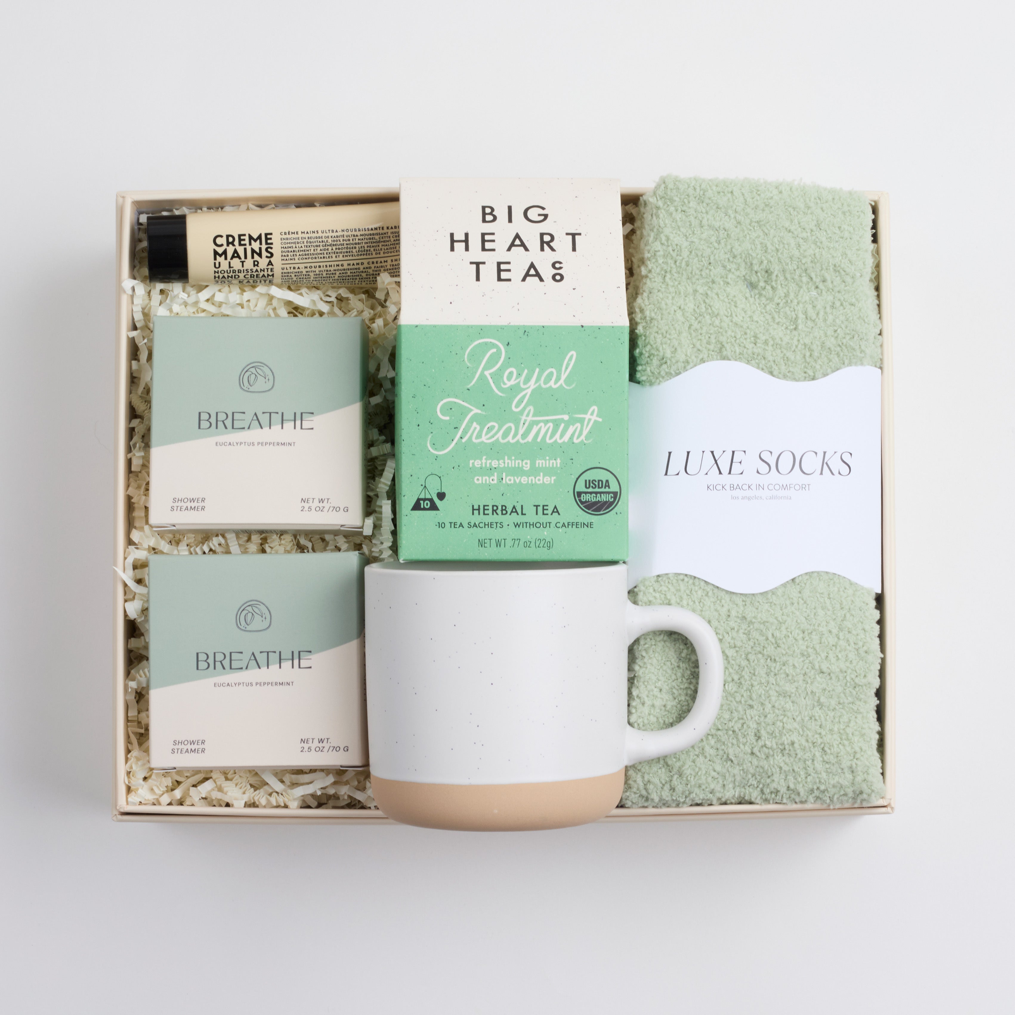 BOXFOX HEAL Gift Box with 2 shower steamers, a travel hand cream, mint & lavender tea, a speckled ceramic mug, and sage cozy socks