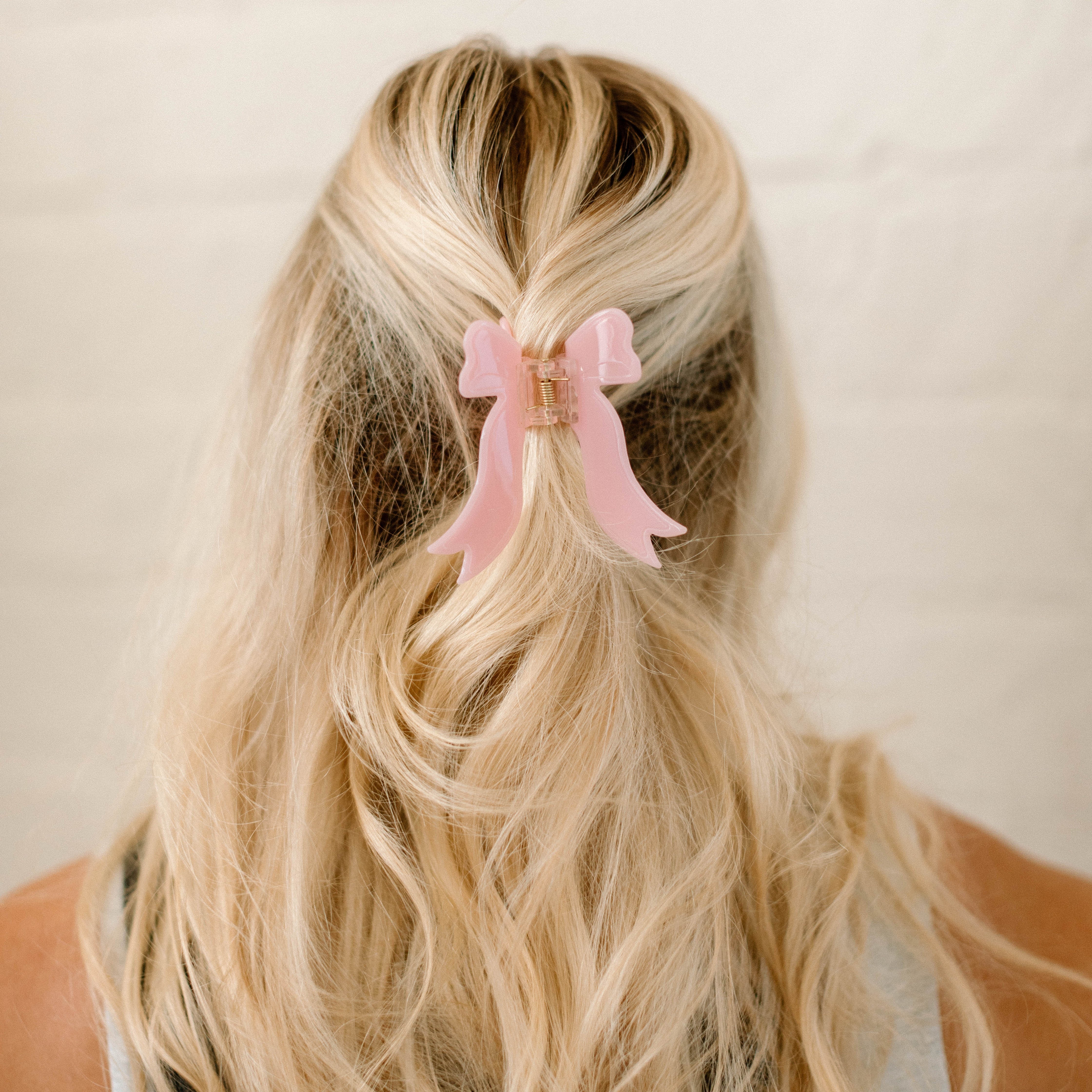 pink bow hair clip in blonde hair