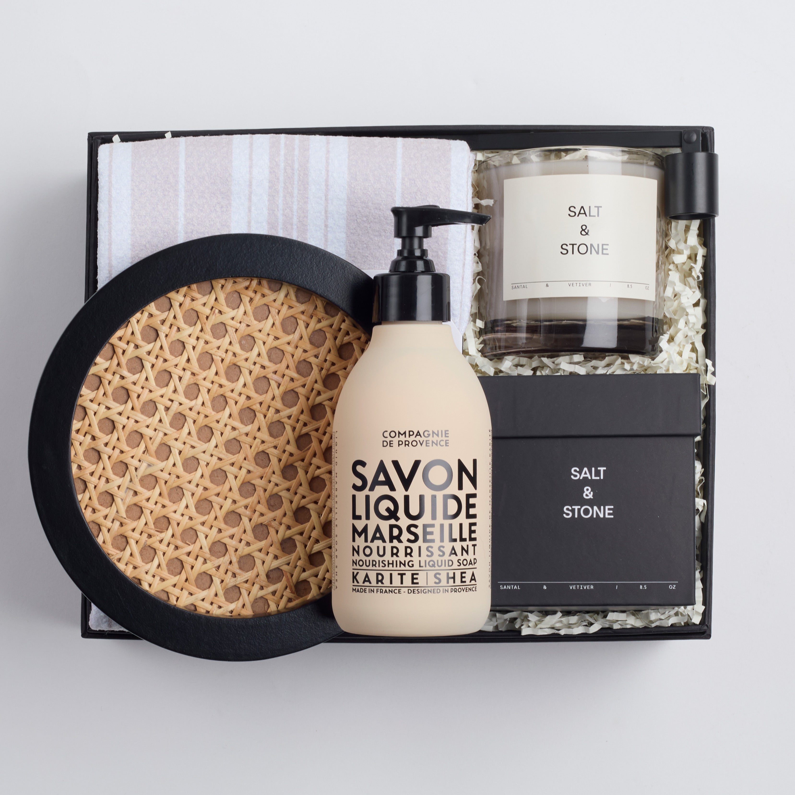 BOXFOX Housewarming Gift Box with a rattan tray, tea towel, hand soap, a candle, and a candle snuffer