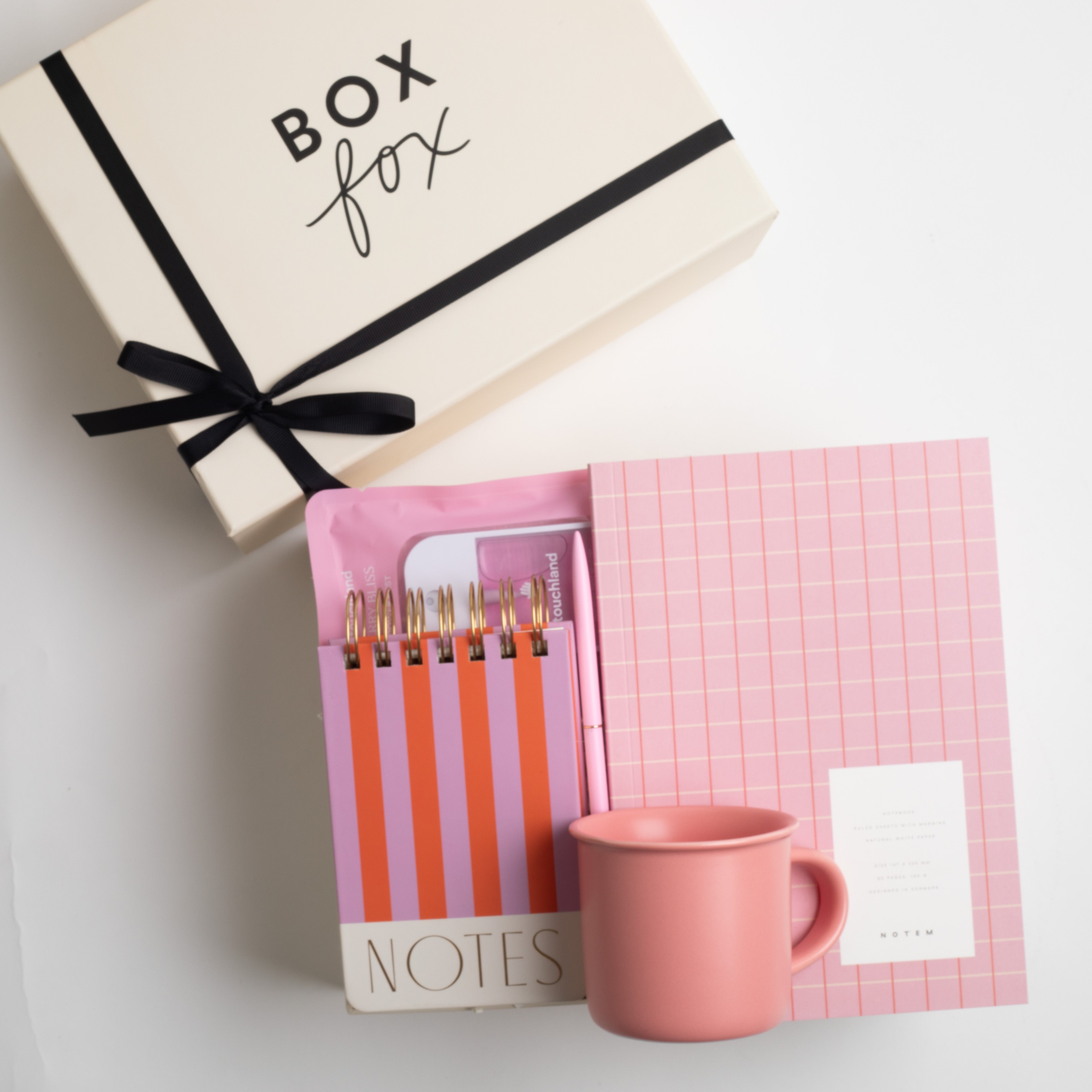 BOXFOX Original Creme Box with Notem Medium Vita Notebook - Rose, BOXFOX Camellia Pink Mug, BOXFOX Pink Bullet Pen, Designworks Pink & Orange Striped Notepad, and Touchland Berry Bliss Power Mist