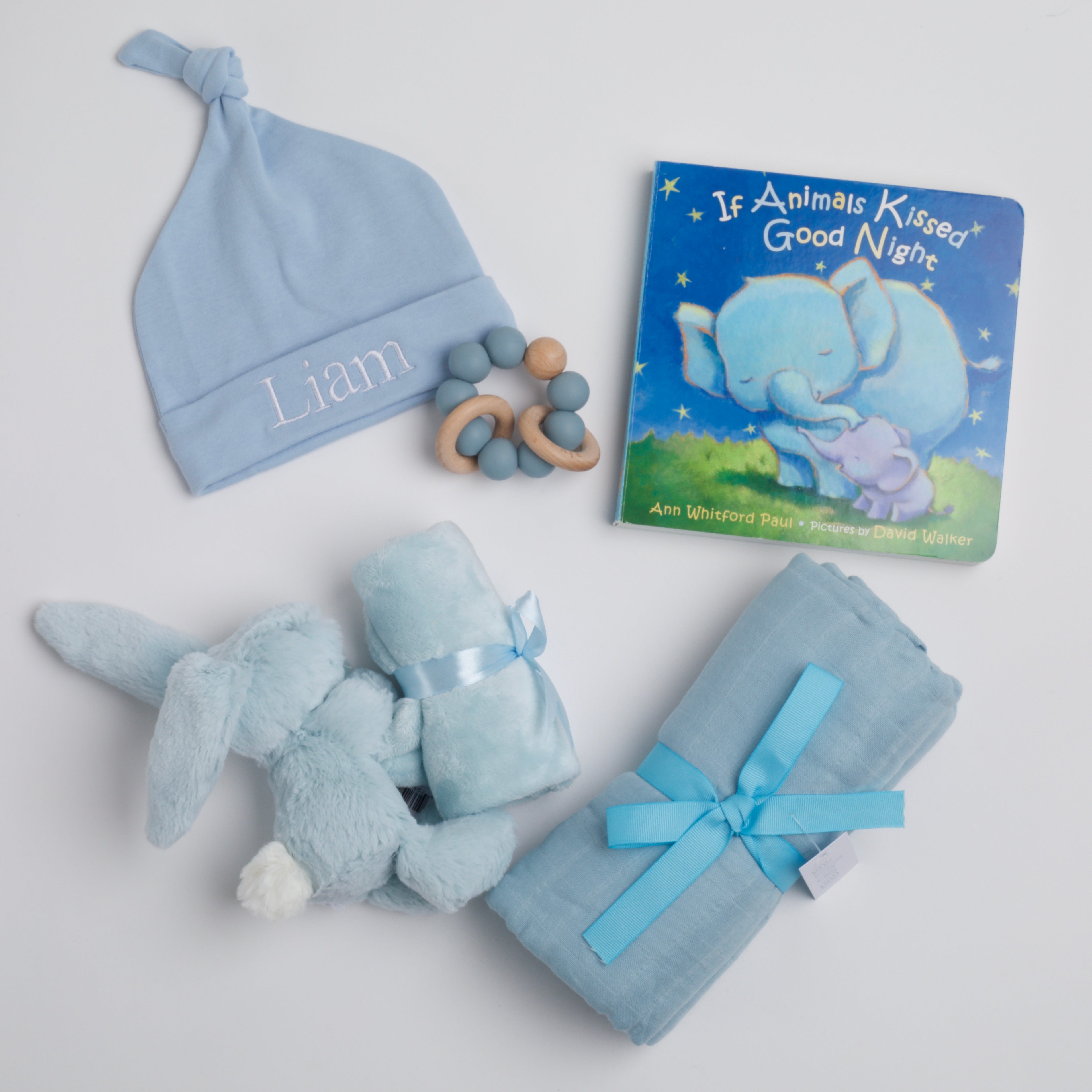 BOXFOX New Baby Boy Box including a swaddle, bunny soother, teether, hat, and book.