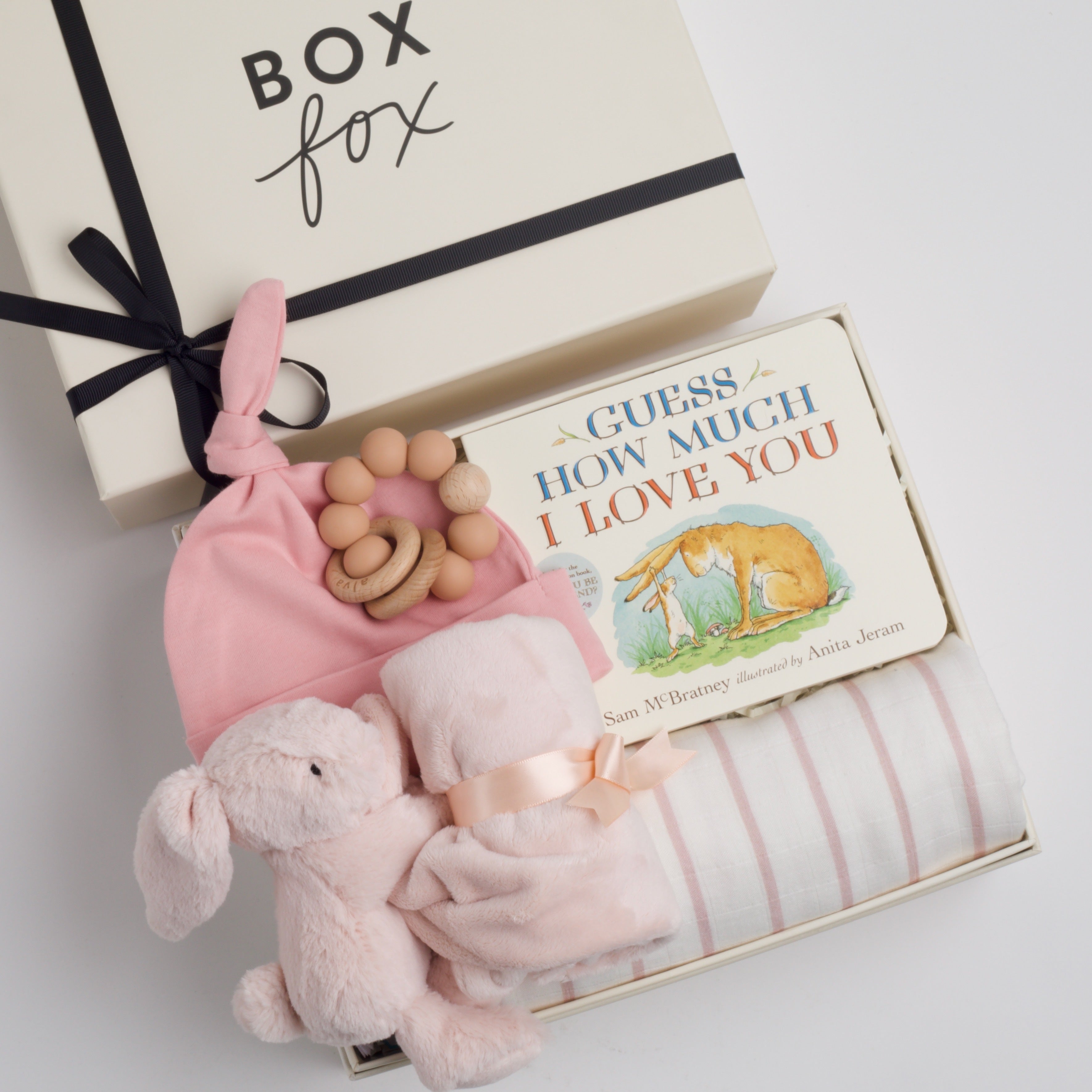 BOXFOX New Baby Girl Box including a swaddle, bunny soother, teether, hat, and book.