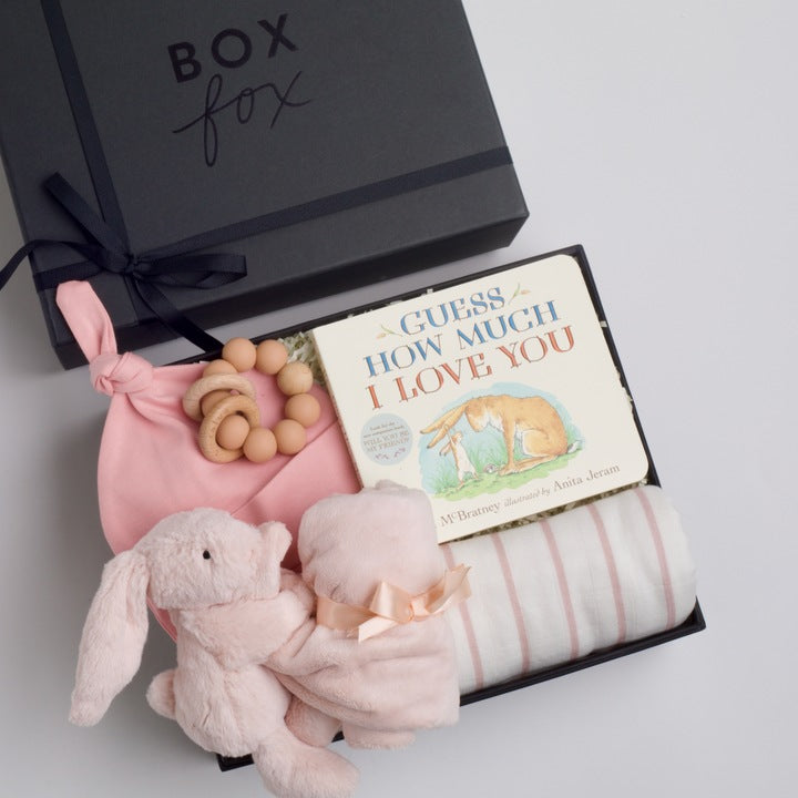 BOXFOX New Baby Girl Box including a swaddle, bunny soother, teether, hat, and book.