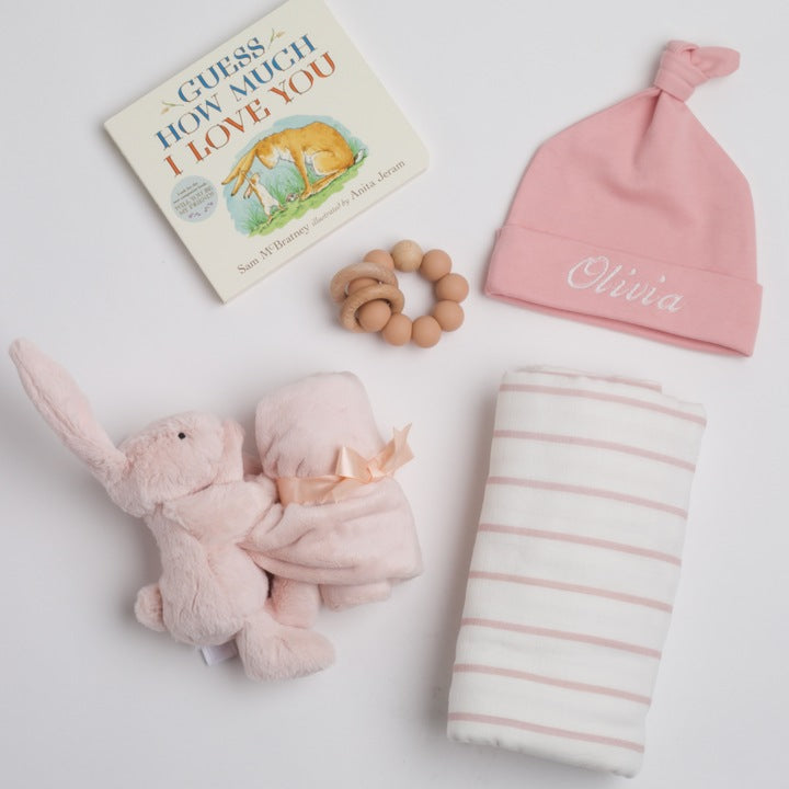 BOXFOX New Baby Girl Box including a swaddle, bunny soother, teether, hat, and book.