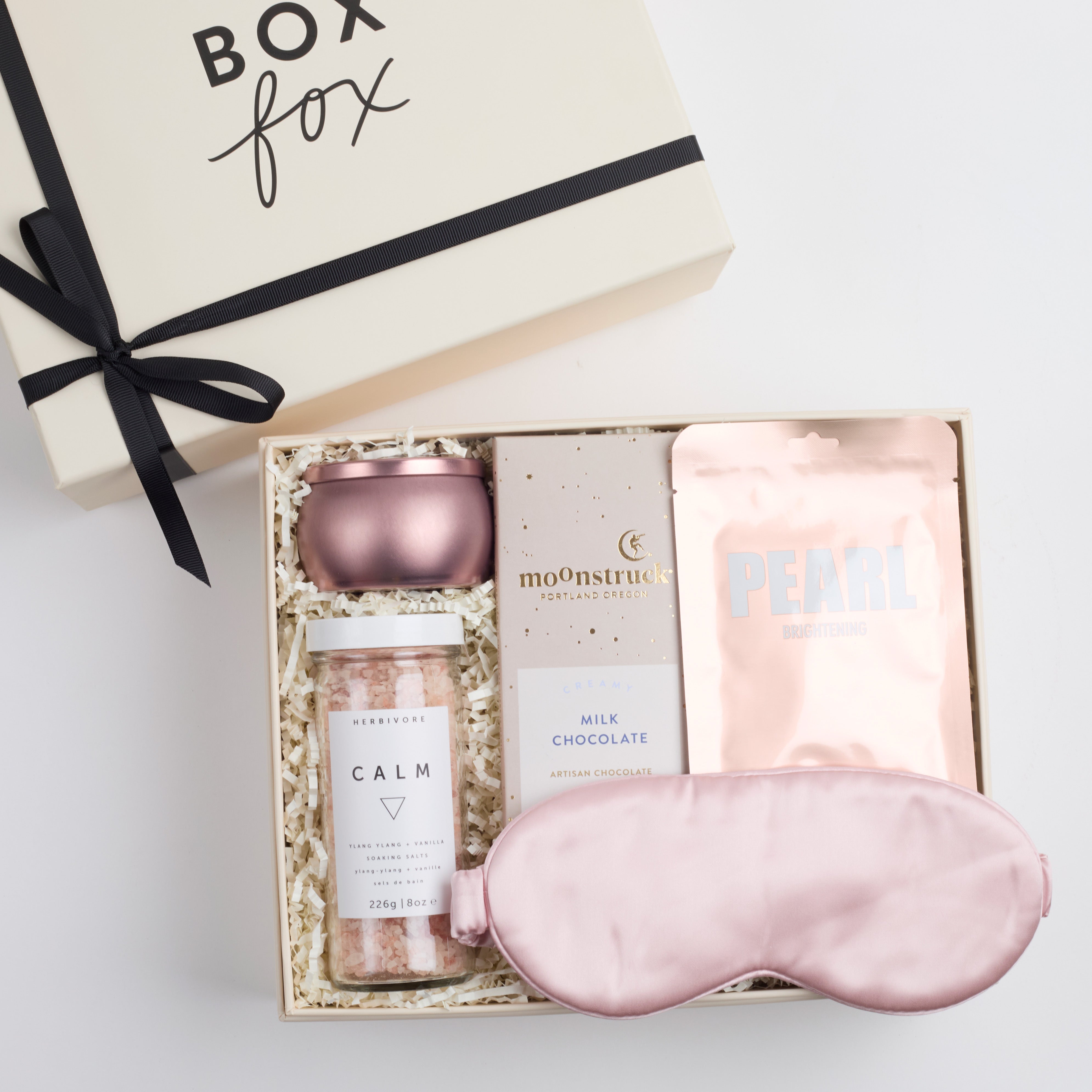 BOXFOX Pink Pamper Gift Box with mini tin candle, bath salts, milk chocolate bar, sheet mask, and silk sleep mask