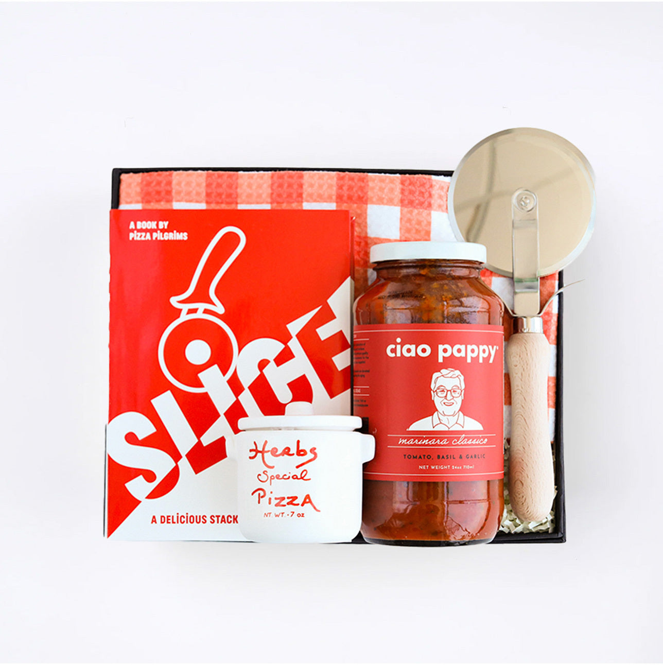 BOXFOX Black gift box packed with "Slice" Pizza book, wood pizza cutter, Ciao Pappy Marinara sauce, Pizza herbs jar and plaid red Geometry tea towel.