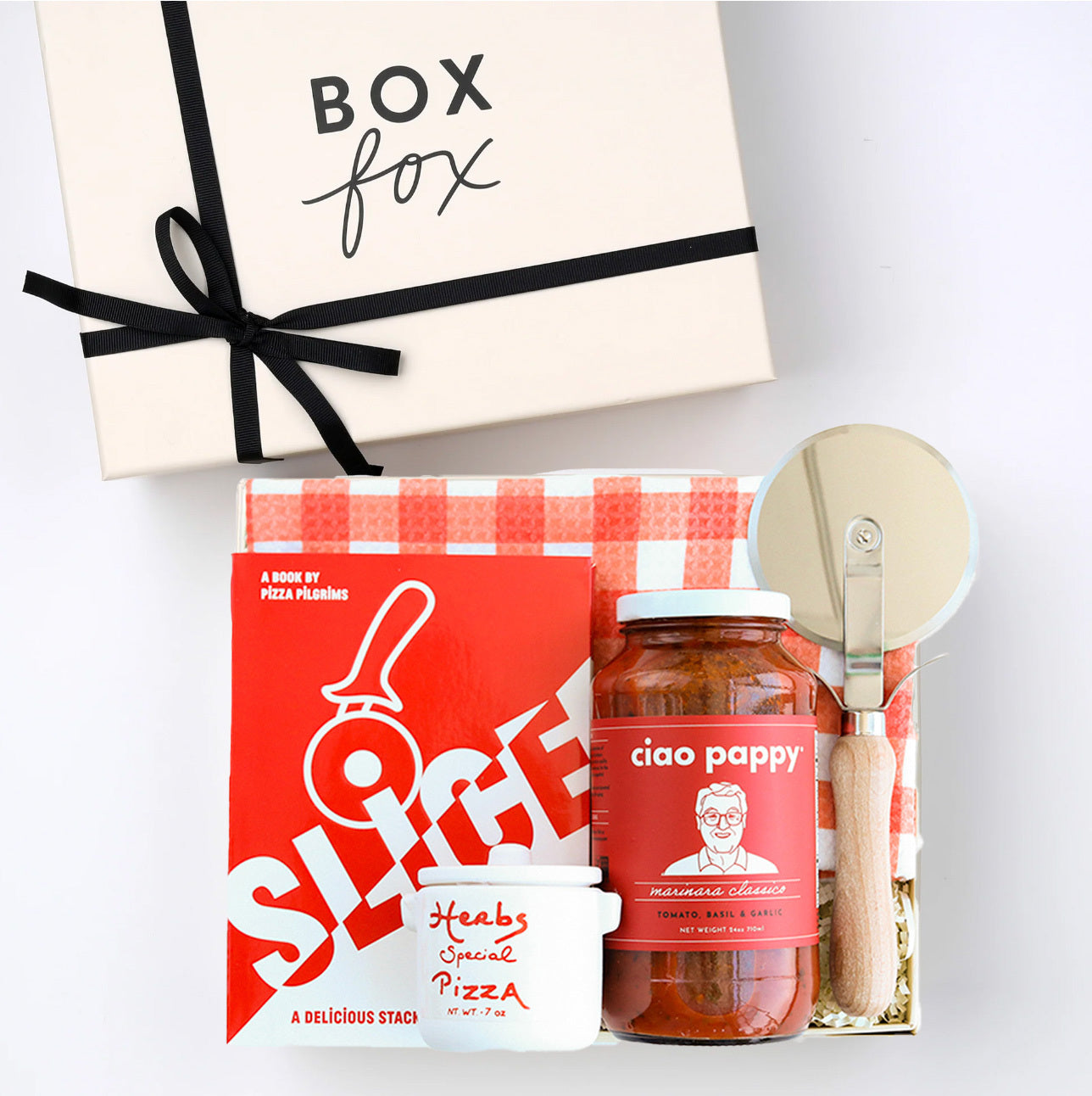BOXFOX creme gift box packed with "Slice" Pizza book, wood pizza cutter, Ciao Pappy Marinara sauce, Pizza herbs jar and plaid red Geometry tea towel.