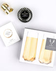 Faceted stemless champagne flutes, sparkling wine gummies, crisp champagne tin candle and gold champagne stopper